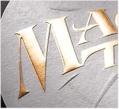 Shiny gold foil lettering on textured label stock