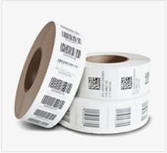 Label rolls showing barcodes, QR codes, and variable printed data
